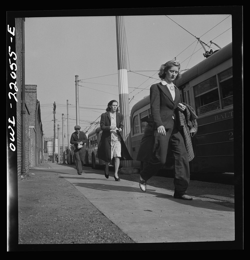 Baltimore, Maryland. Rushing to catch the trackless trolleys home from work at four p.m.. Sourced from the Library of…