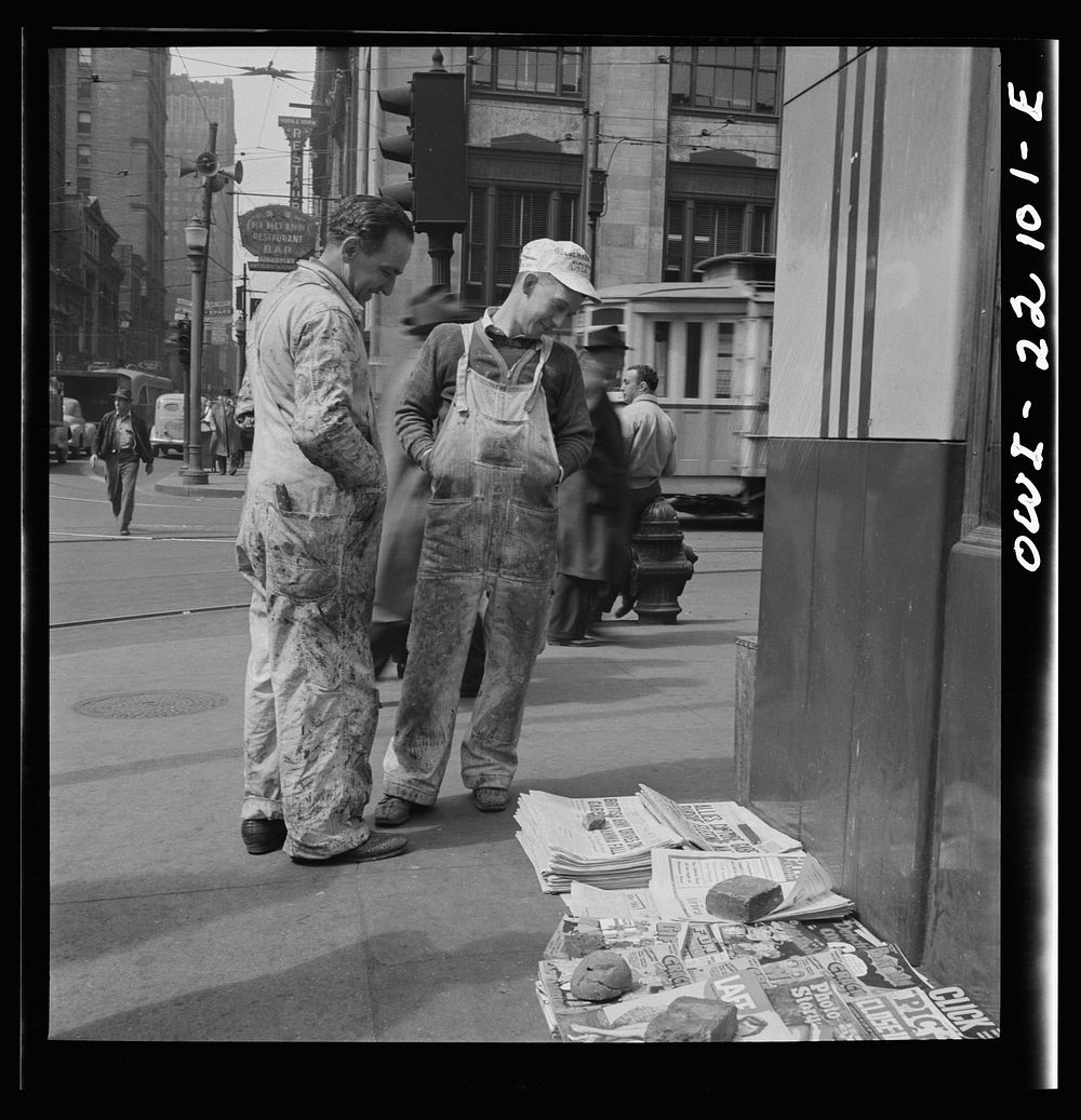 Baltimore, Maryland. Workers reading the newsstand papers while waiting for a trolley after work. Sourced from the Library…