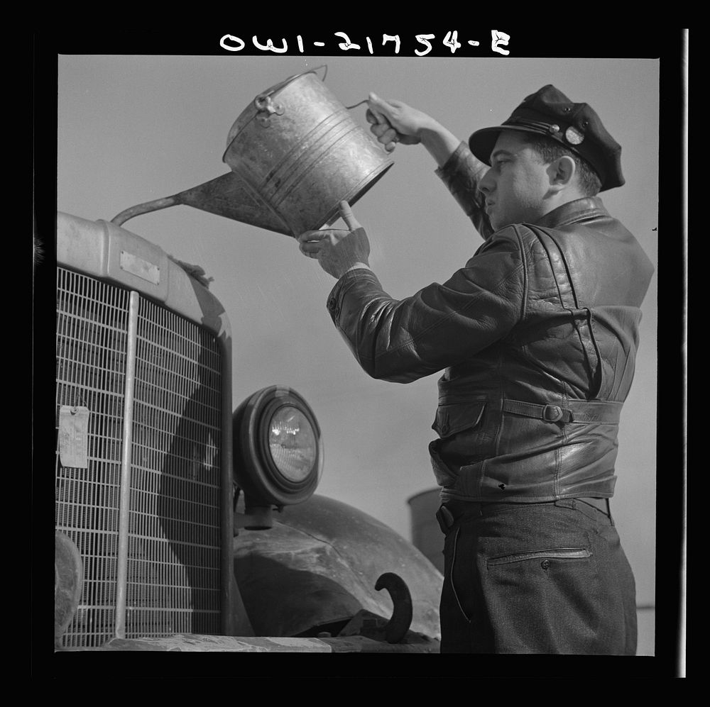 Melvin Cash, truck driver, putting water in his radiator along U.S. Highway 29 in North Carolina enroute to Charlotte.…