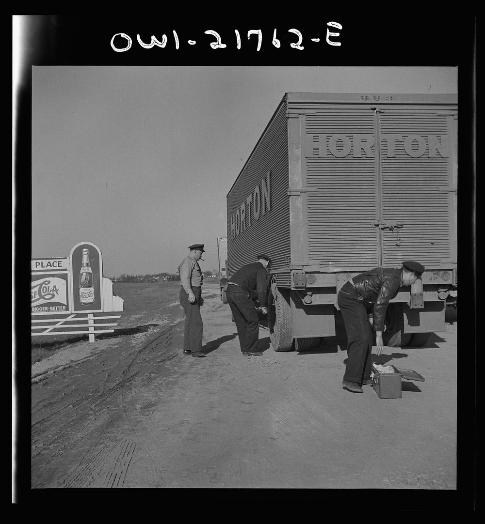 Truck drivers changing a tire along U.S. Highway 29 in North Carolina. Sourced from the Library of Congress.