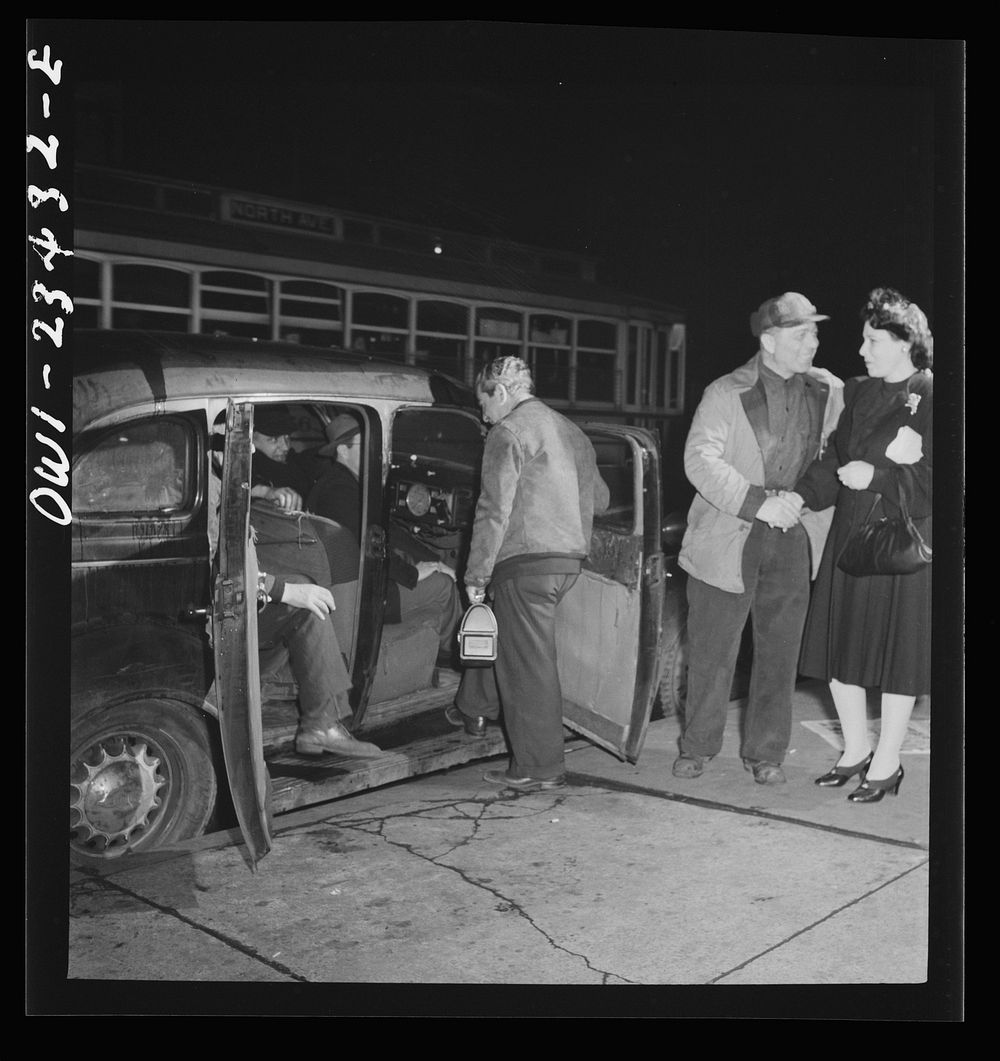 Baltimore, Maryland. Third shift defense workers being picked up by a car pool around midnight. Sourced from the Library of…