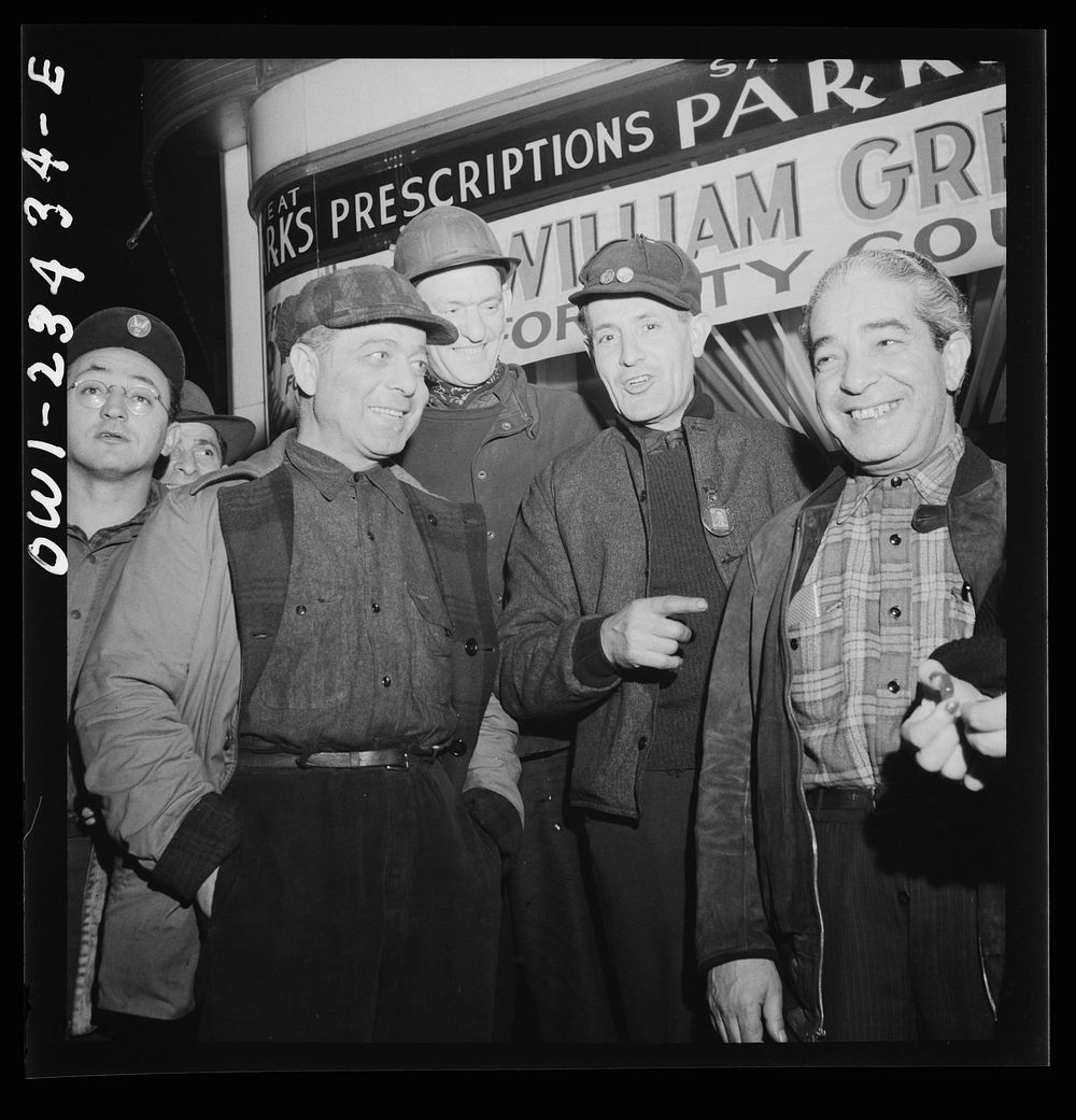 Baltimore, Maryland. Third shift workers waiting on a street corner to be picked up by car pools around midnight. Sourced…