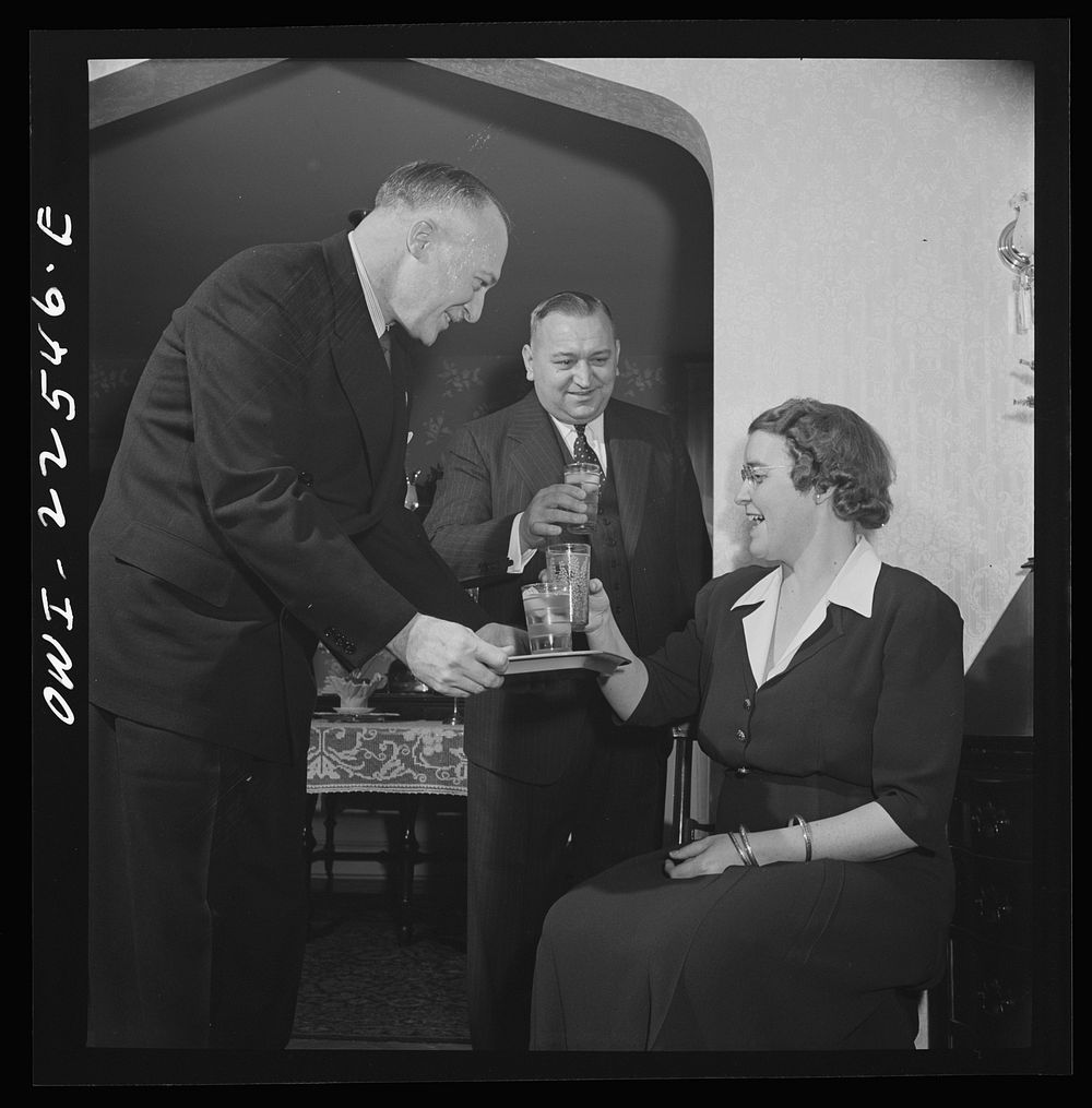 Philadelphia, Pennsylvania. Swedish-American executive of the SKF roller bearing factory serving drinks to his wife and a…