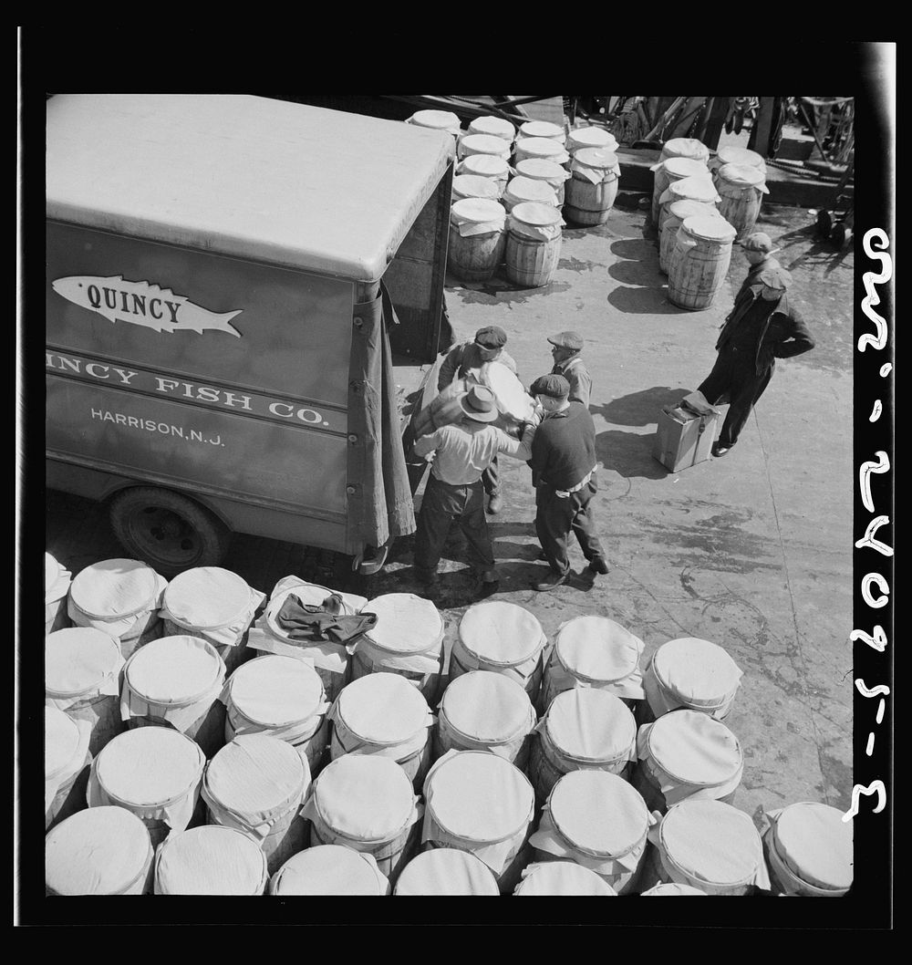 New York, New York. Barrels of fish on the docks at Fulton fish market ready to be shipped to retailers. Sourced from the…