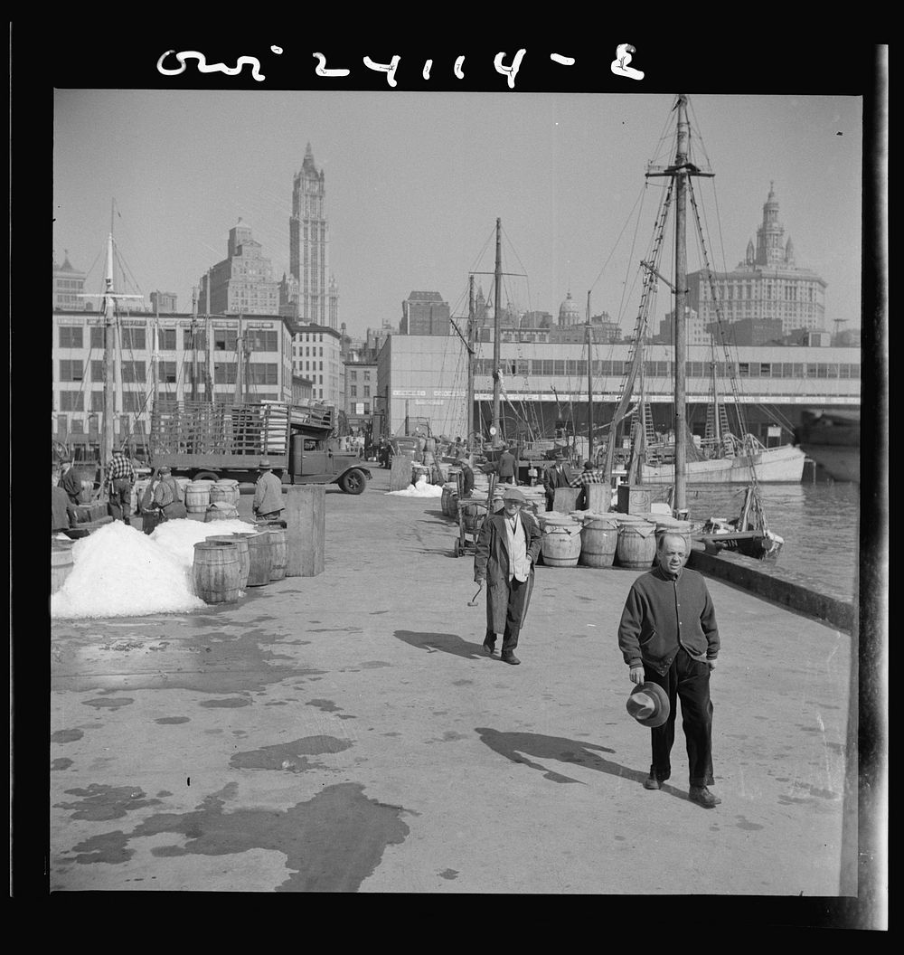 [Untitled photo, possibly related to: New York, New York. Barrels of fish on the docks at Fulton fish market ready to be…