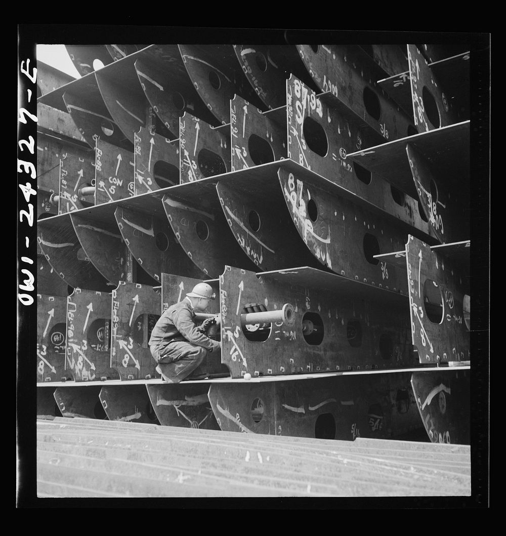Bethlehem-Fairfield shipyards, Baltimore, Maryland. Pipefitters at work in the innerbottom sections. Sourced from the…