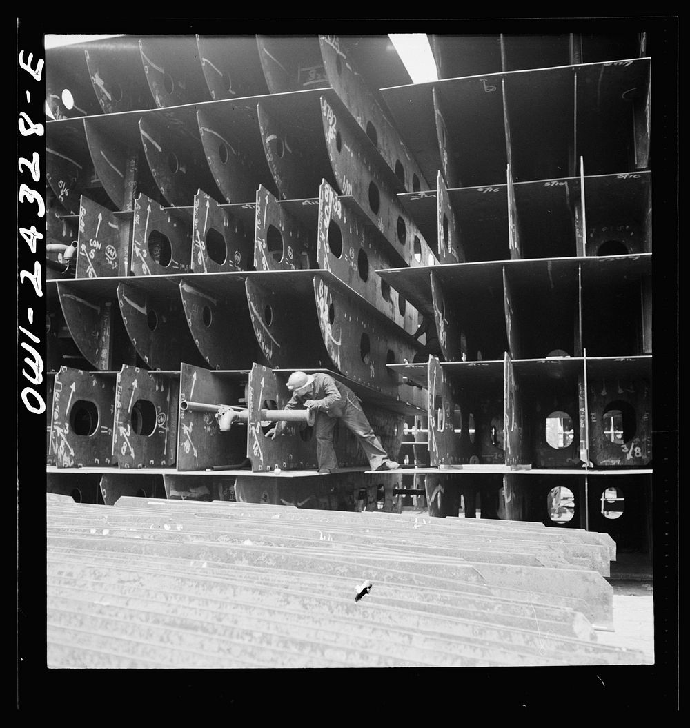 Bethlehem-Fairfield shipyards, Baltimore, Maryland. Pipefitters at work in the innerbottom sections. Sourced from the…
