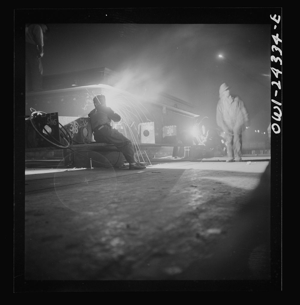[Untitled photo, possibly related to: Baltimore, Maryland. Third shift workers waiting on street corner to be picked up by…