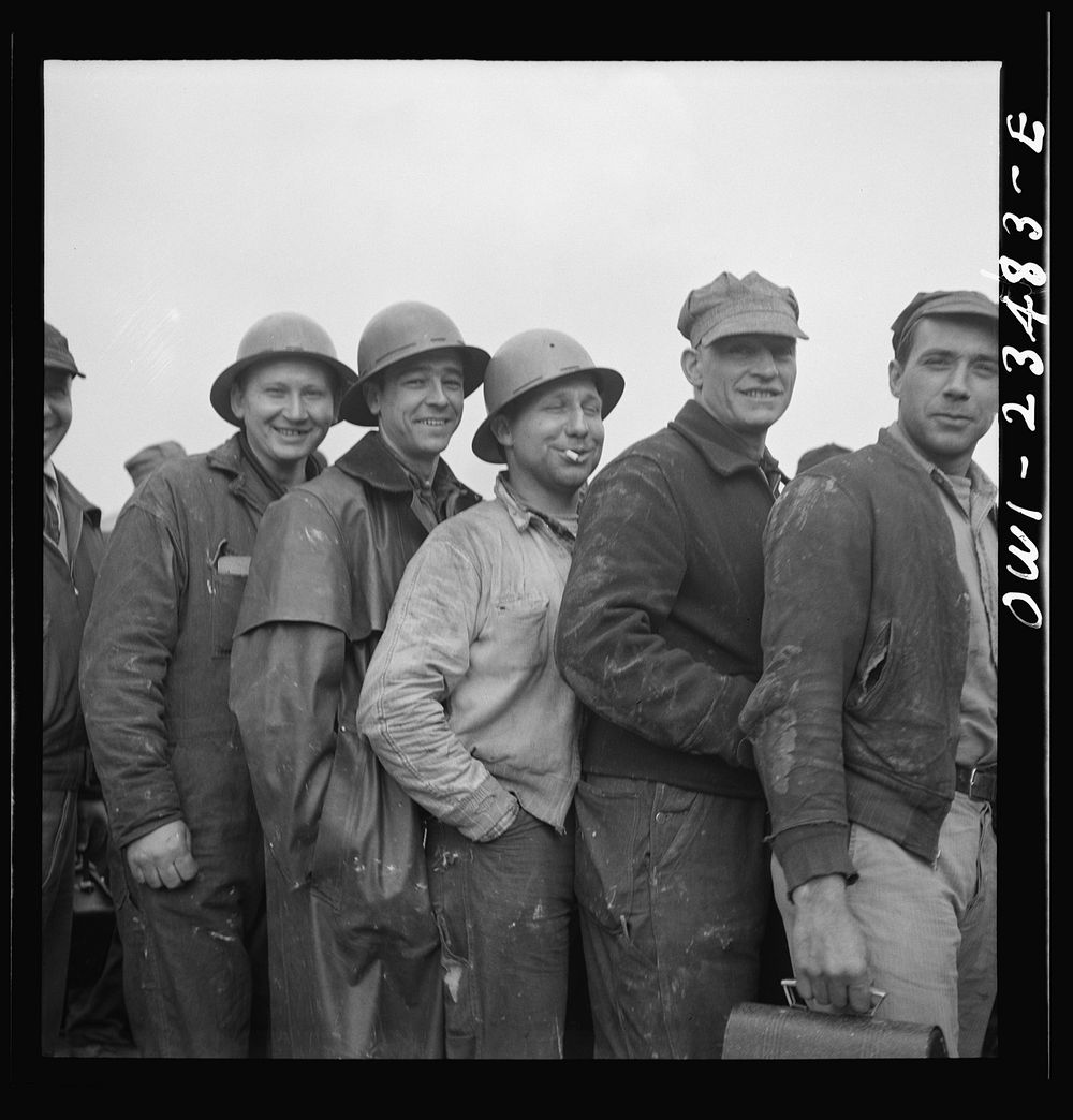 Bethlehem-Fairfield shipyards, Baltimore, Maryland. Lining up before a time clock at the changing of the shifts. Sourced…