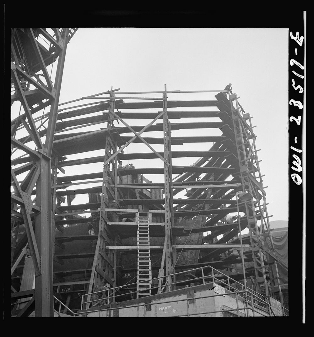 Bethlehem-Fairfield shipyards, Baltimore, Maryland. Looking at the forepeak of a vessel through staging. Sourced from the…