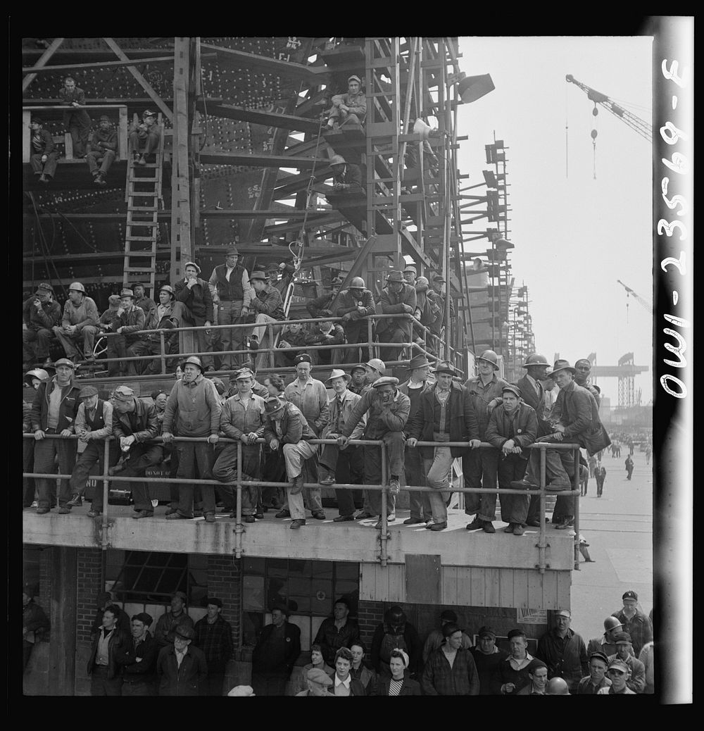 Bethlehem-Fairfield shipyards, Baltimore, Maryland. Shipyard workers watching a launching ceremony. Sourced from the Library…