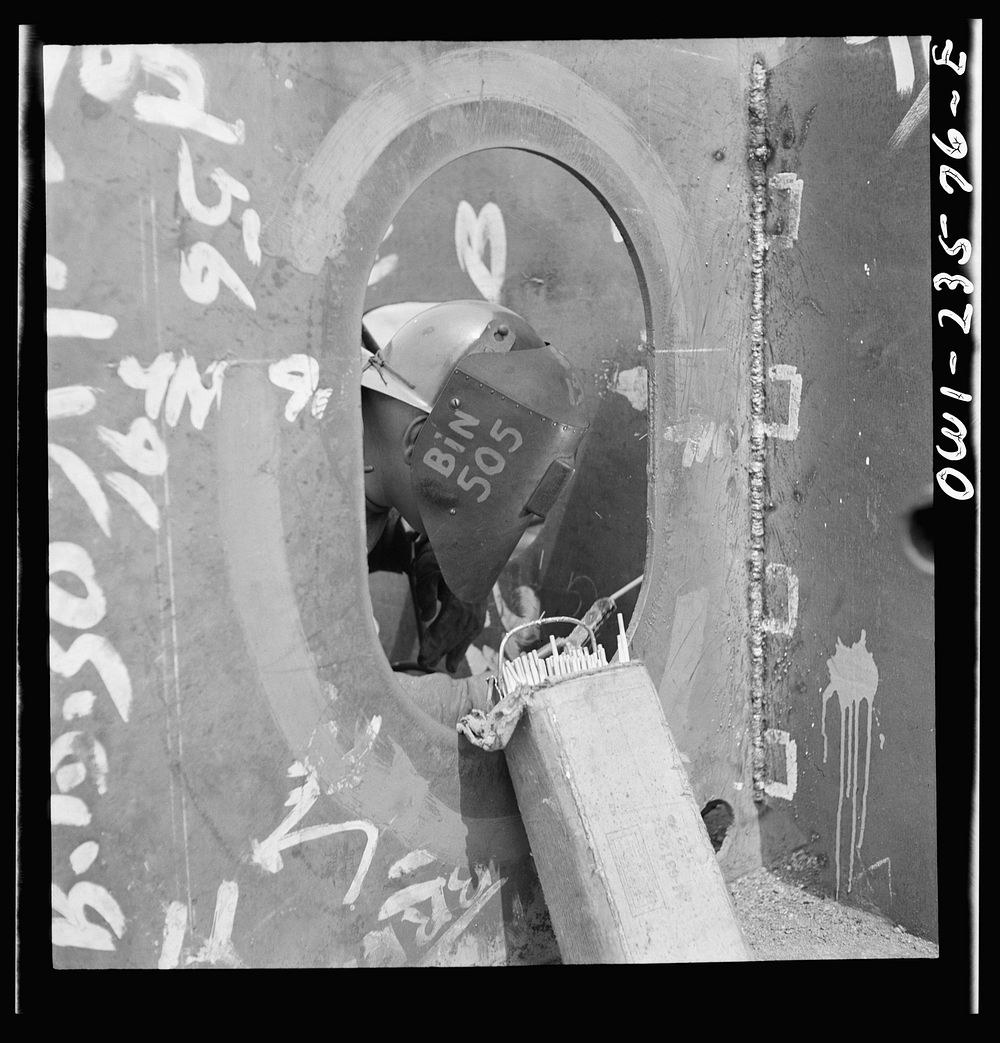 [Untitled photo, possibly related to: Bethlehem-Fairfield shipyards, Baltimore, Maryland. Welding the floor to a vertical…