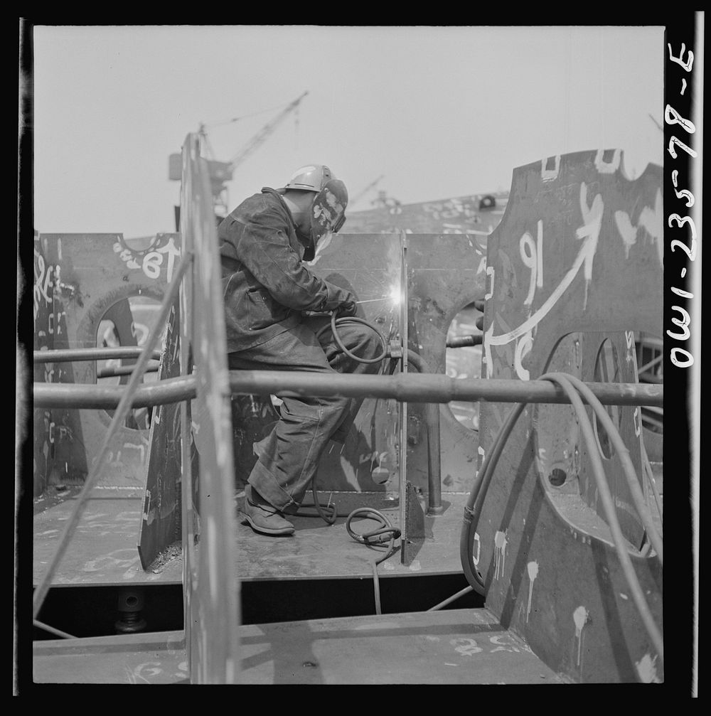 Bethlehem-Fairfield shipyards, Baltimore, Maryland. Welding the floor to a vertical keel. Sourced from the Library of…