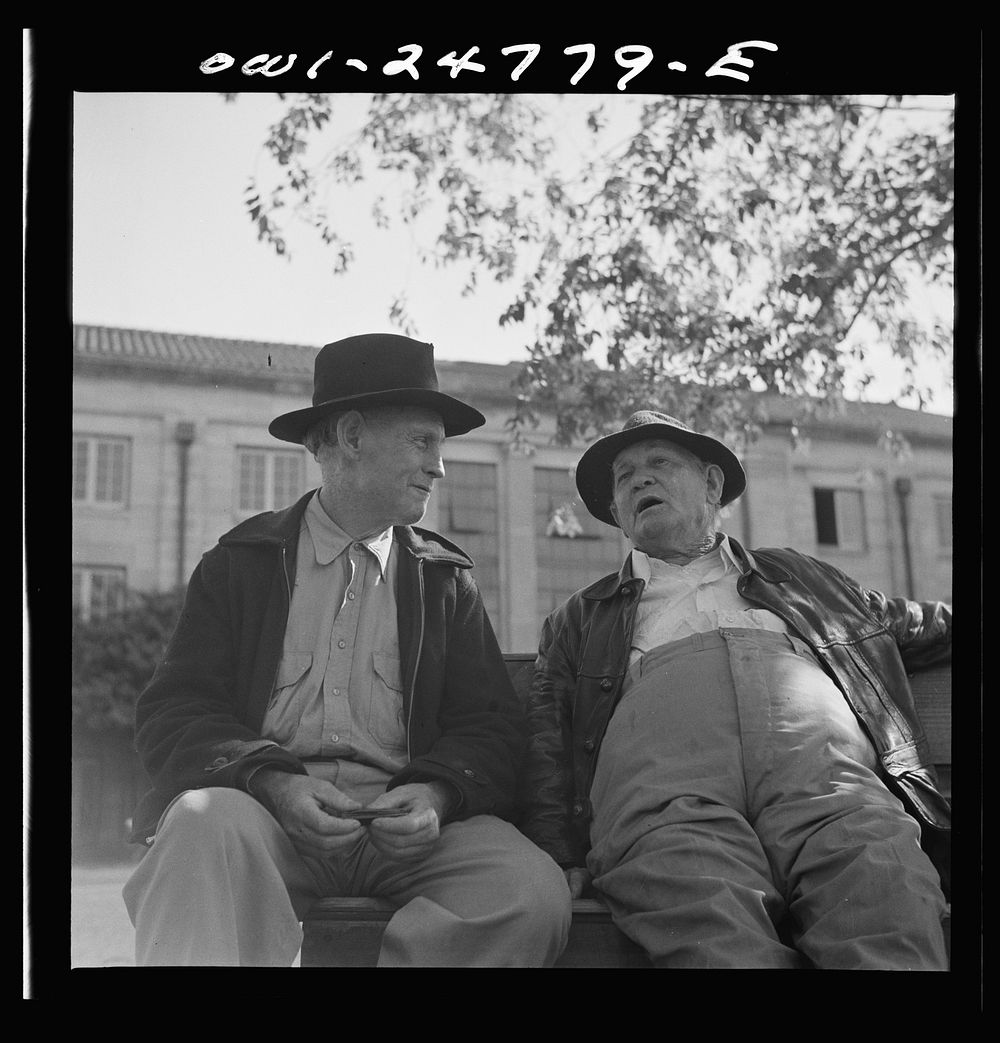 San Augustine, Texas. Men talking on a park bench in Courthouse Square. Sourced from the Library of Congress.
