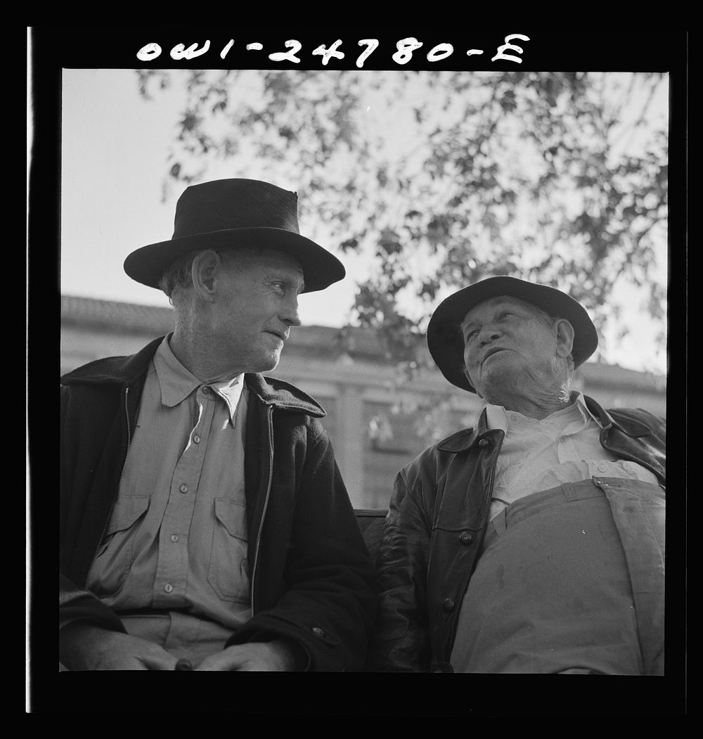 [Untitled photo, possibly related to: San Augustine, Texas. Men talking on a park bench in Courthouse Square]. Sourced from…