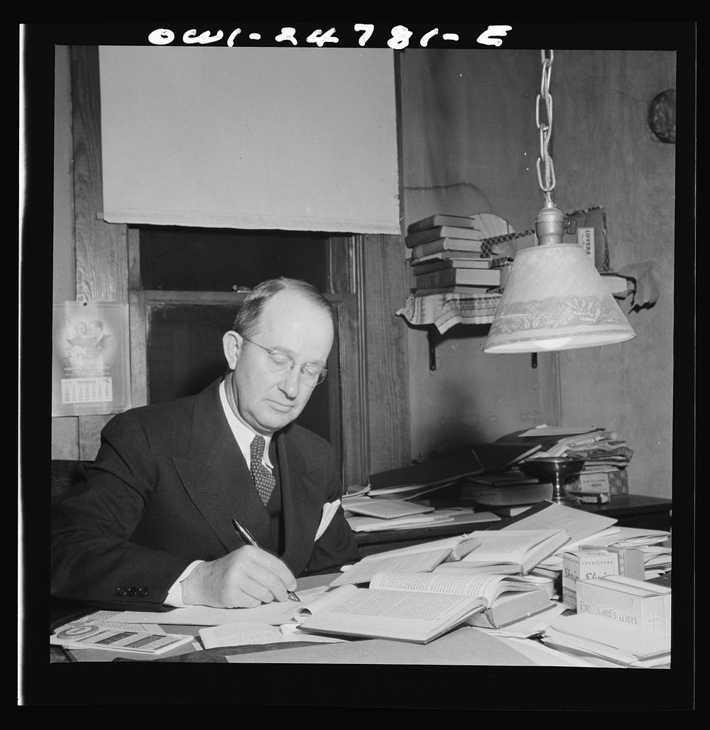 San Augustine, Texas. Reverend Marsh Calloway, Presbyterian minister, preparing his Easter sermon in his study. Sourced from…
