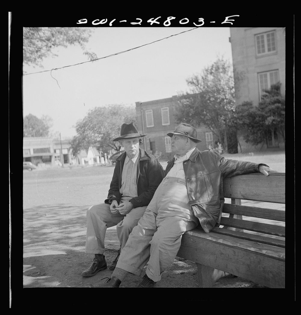 [Untitled photo, possibly related to: San Augustine, Texas. Men talking on a park bench in Courthouse Square]. Sourced from…