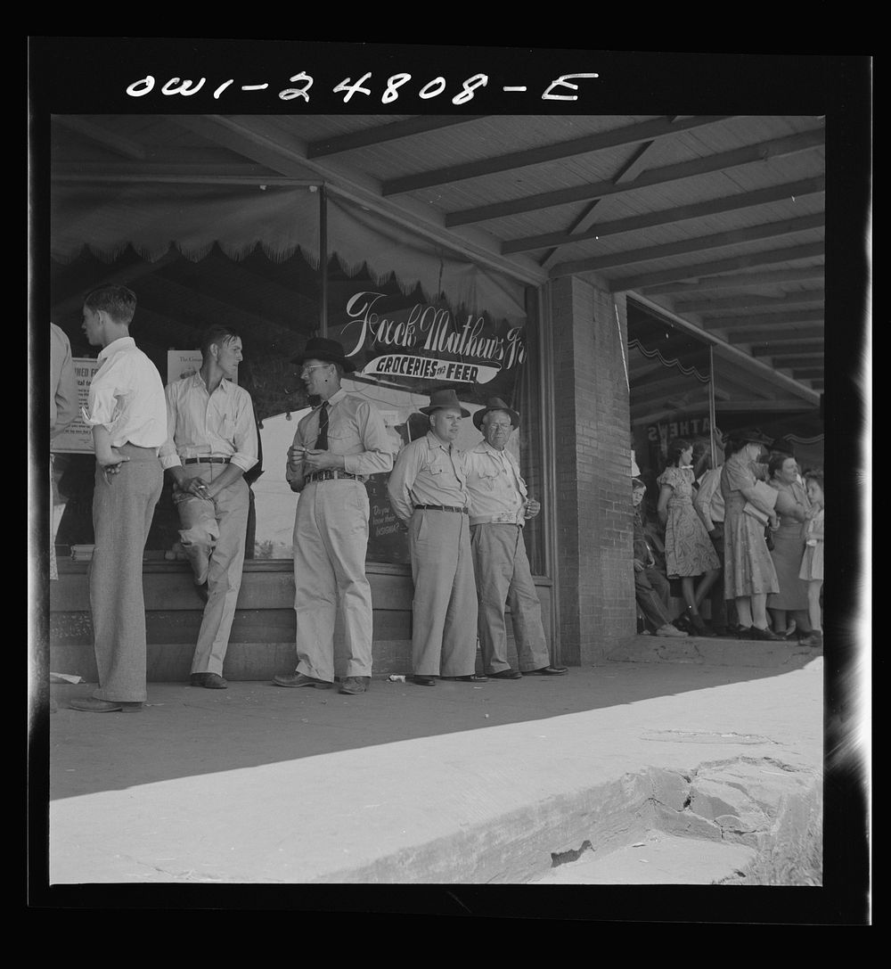 San Augustine, Texas. Men standing in front of the grocery and feed store. Sourced from the Library of Congress.