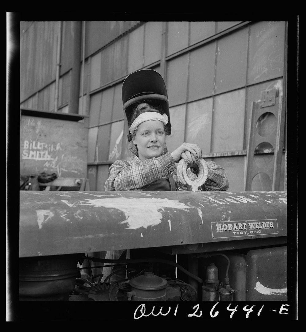 Bethlehem-Fairfield shipyards, Baltimore, Maryland. Girl welder resting on a welding machine. Sourced from the Library of…