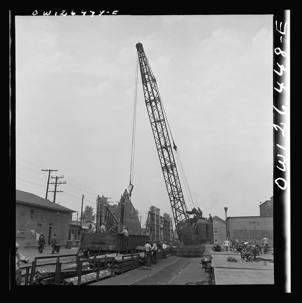 Bethlehem-Fairfield shipyards, Baltimore, Maryland. Transferring a steel section from the fabricating table to a railroad…