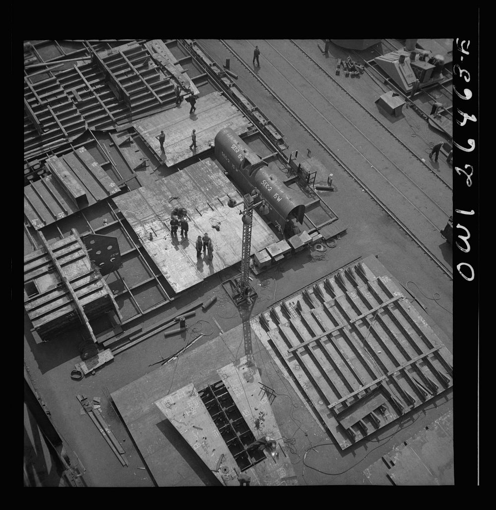 Bethlehem-Fairfield shipyards, Baltimore, Maryland. Transferring a completed section to the ship. Sourced from the Library…