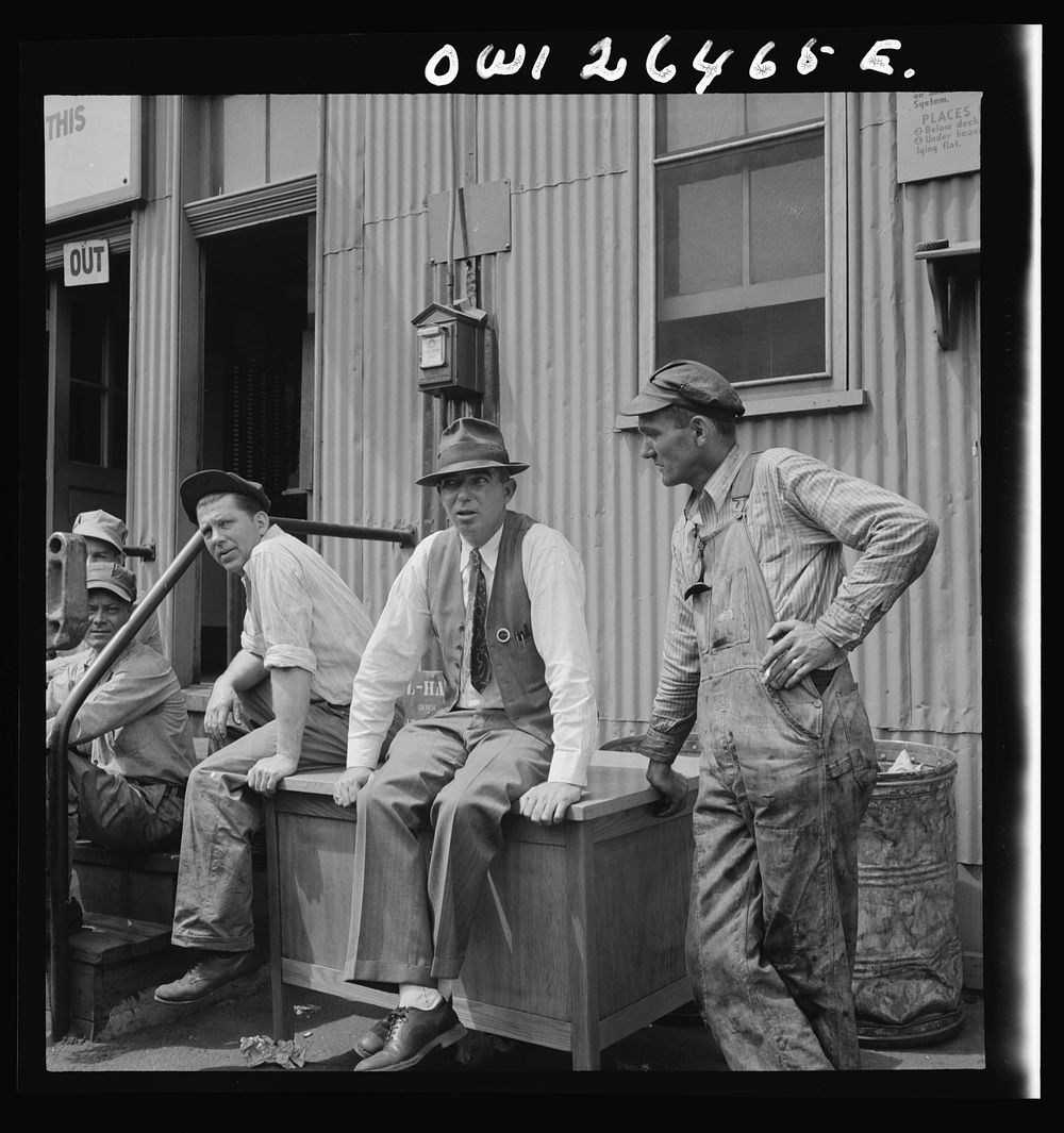 Bethlehem-Fairfield shipyards, Baltimore, Maryland. Workers and their foreman during the lunch hour. Sourced from the…