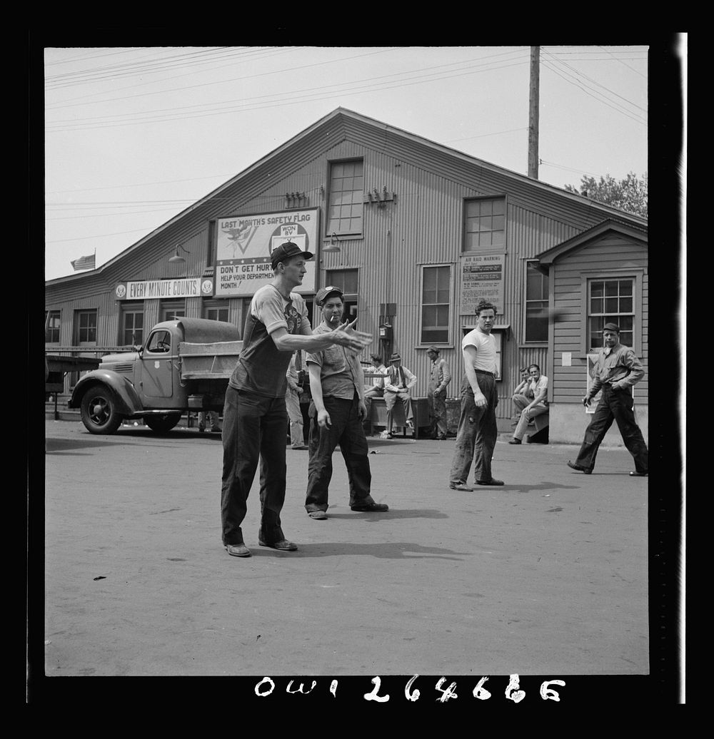 Bethlehem-Fairfield shipyards, Baltimore, Maryland. Playing a game of catch during lunch hour. Sourced from the Library of…