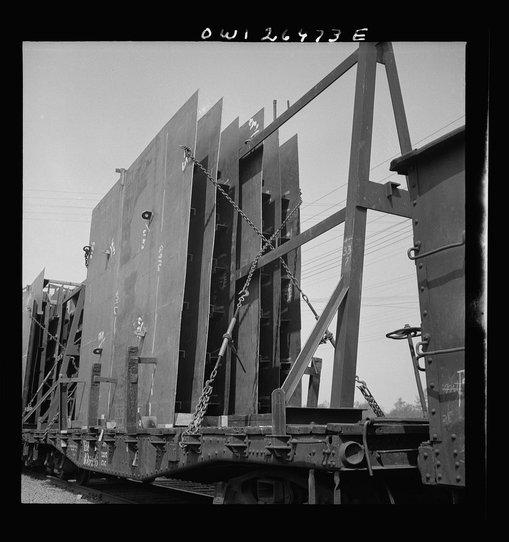 Bethlehem-Fairfield shipyards, Baltimore, Maryland. Method of attaching steel sections to a flatcar. Sourced from the…