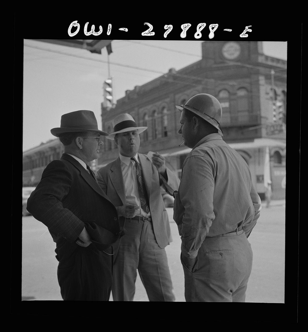 Orange, Texas. Shipyard worker talking with two friends. Sourced from the Library of Congress.