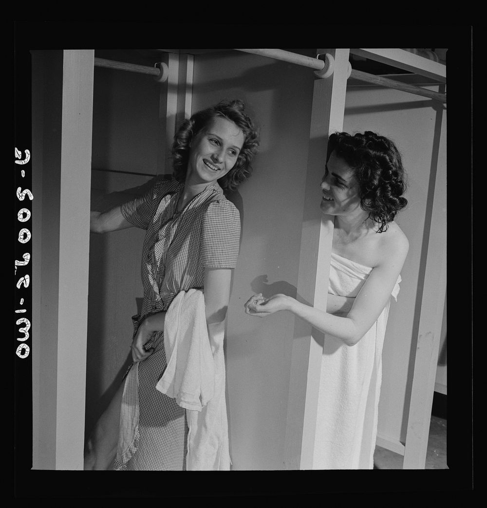 Arlington, Virginia. Girls in two of the long line of showers at Idaho Hall, Arlington Farms, a residence for women who work…
