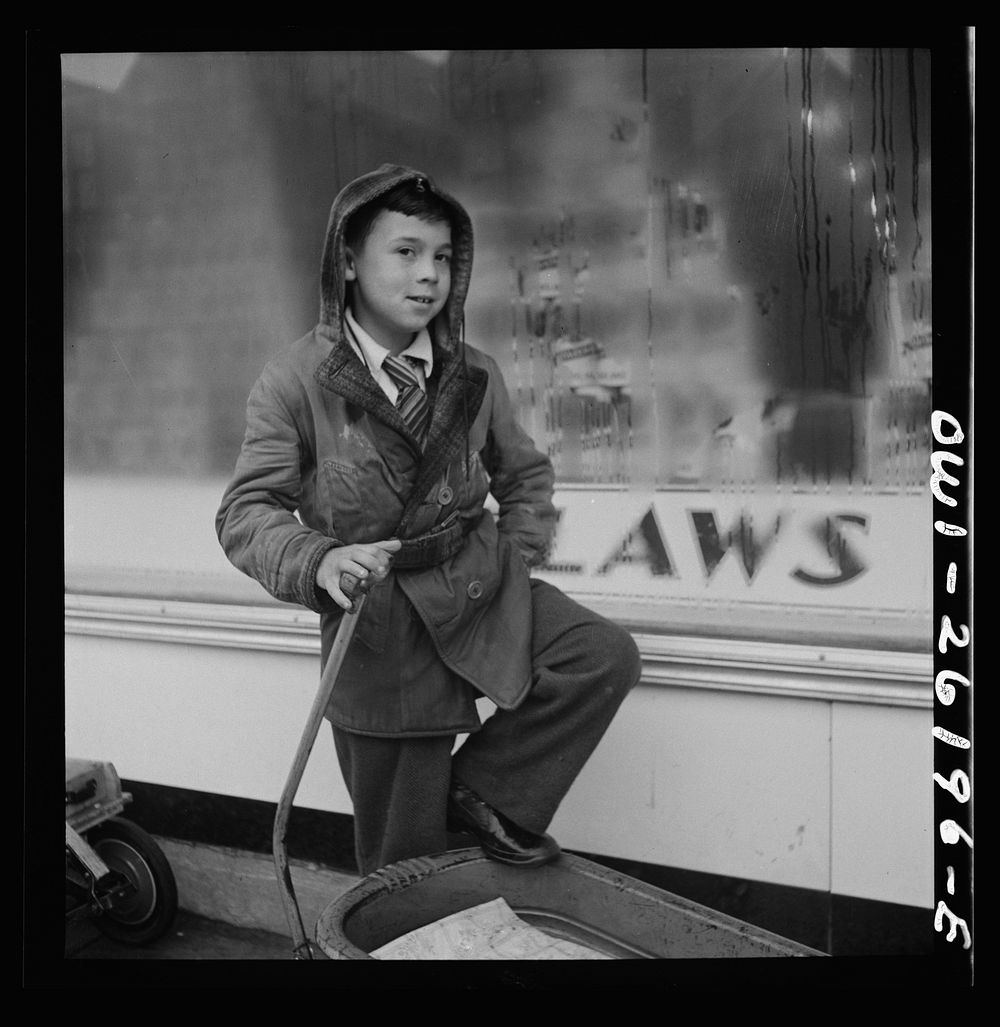 Buffalo, New York. Peter Grimm, age ten, waiting with his wagon outside Loblaw's grocery store for customers to ask him to…