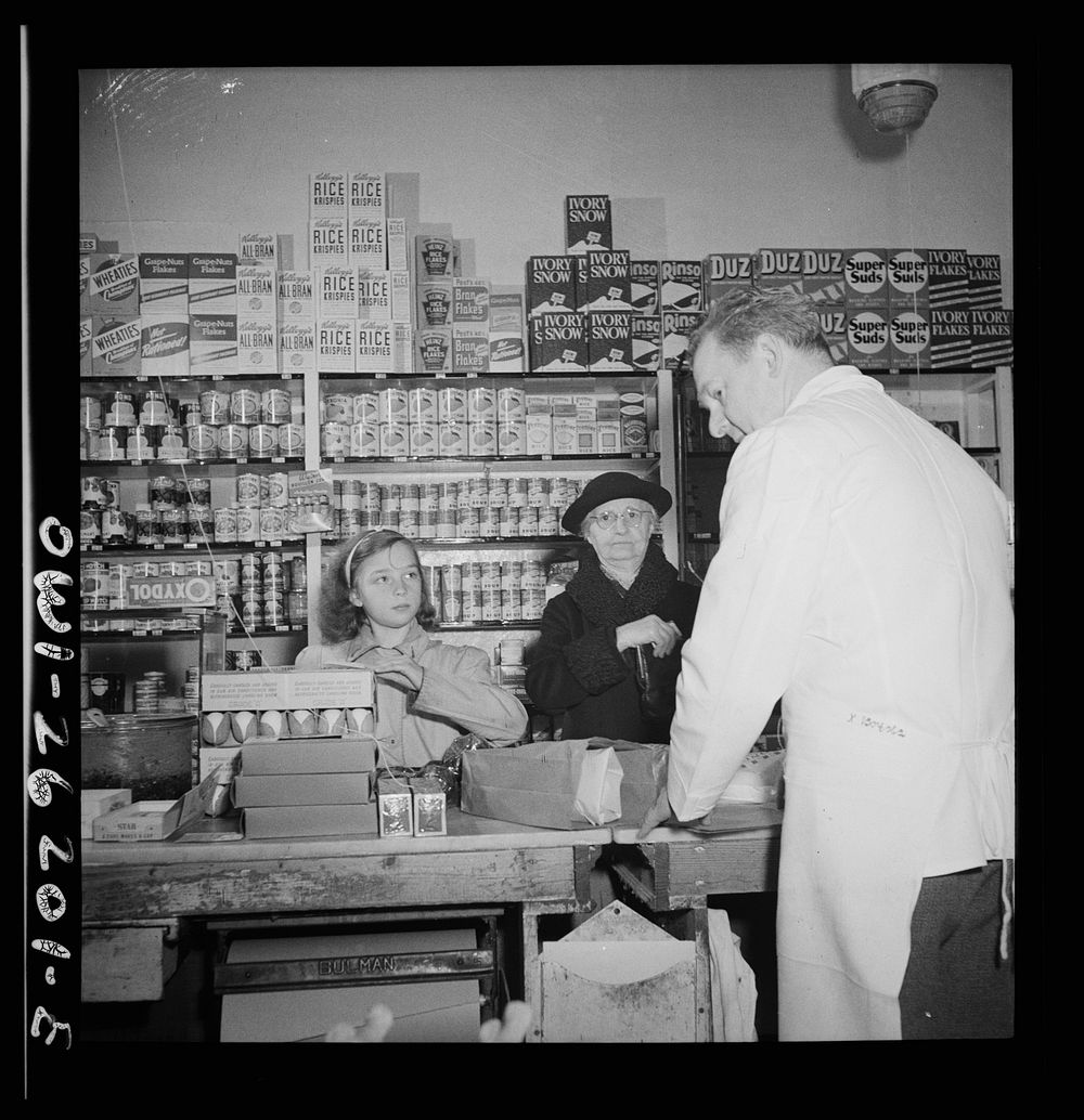 Buffalo, New York. Beverly Ann Grimm, eleven, doing the family shopping. She is making purchases from a list left that…