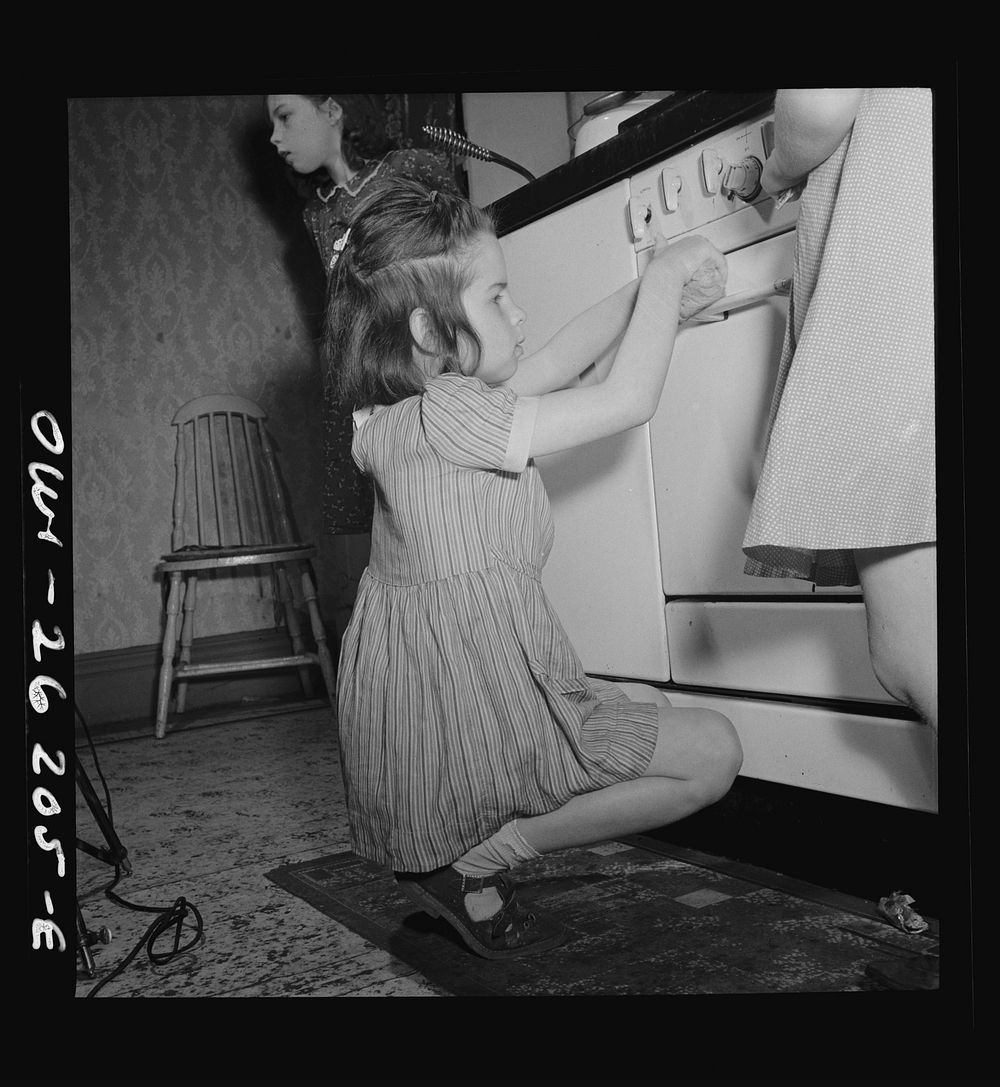 Buffalo, New York. The Grimm children doing the housework. The mother, a twenty-six year old widow, is a crane operator at…