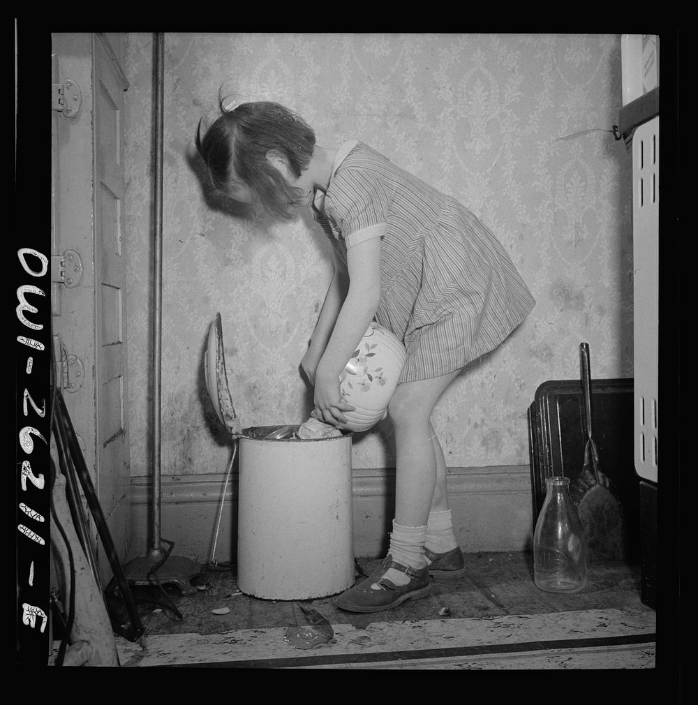 Buffalo, New York. Mary Grimm, eight, doing the housework.  Her mother, a twenty-six year old widow, is a crane operator at…