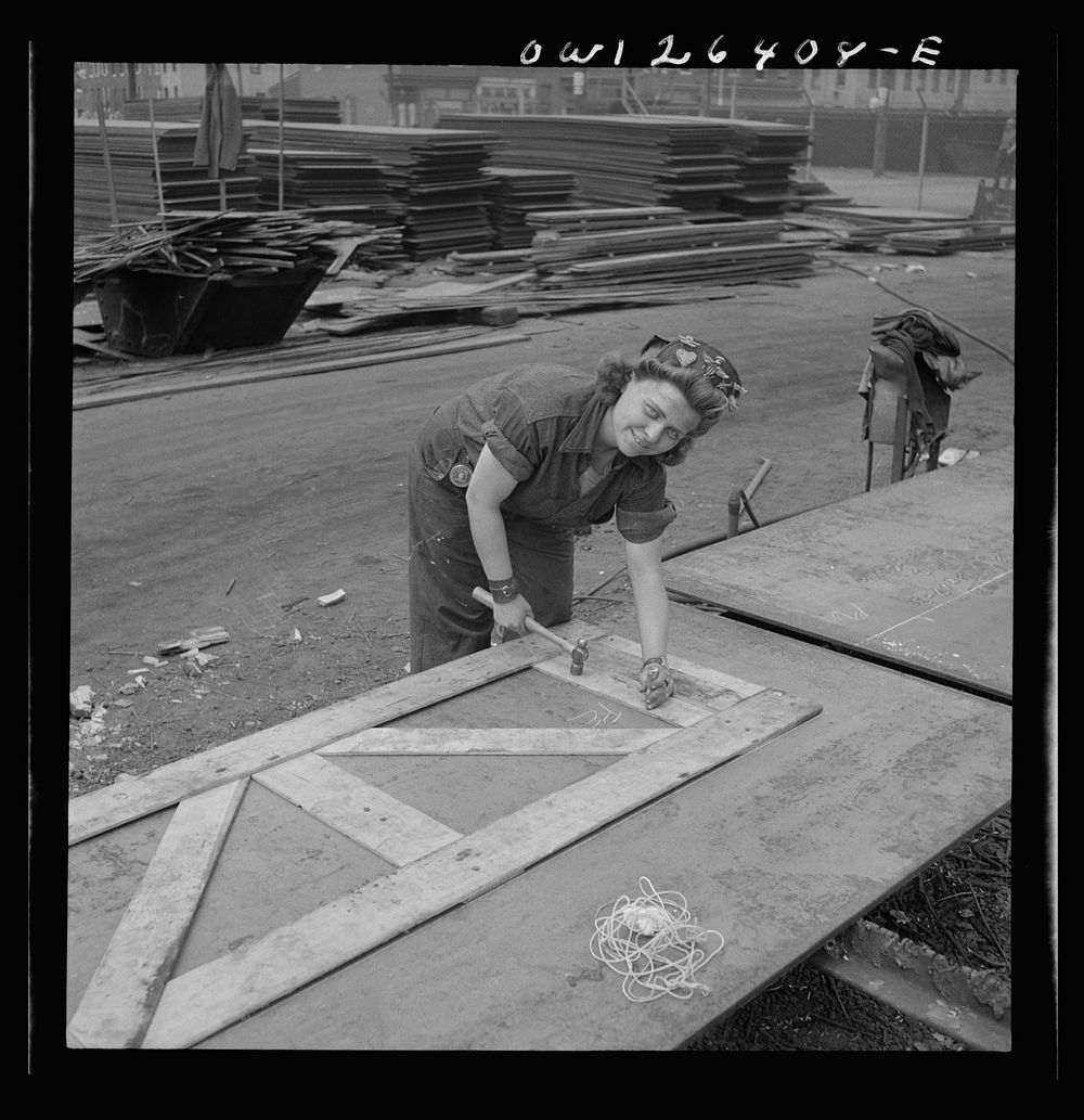 Bethlehem-Fairfield shipyards, Baltimore, Maryland. Punching down the wooden templates to mark out the steel. Sourced from…