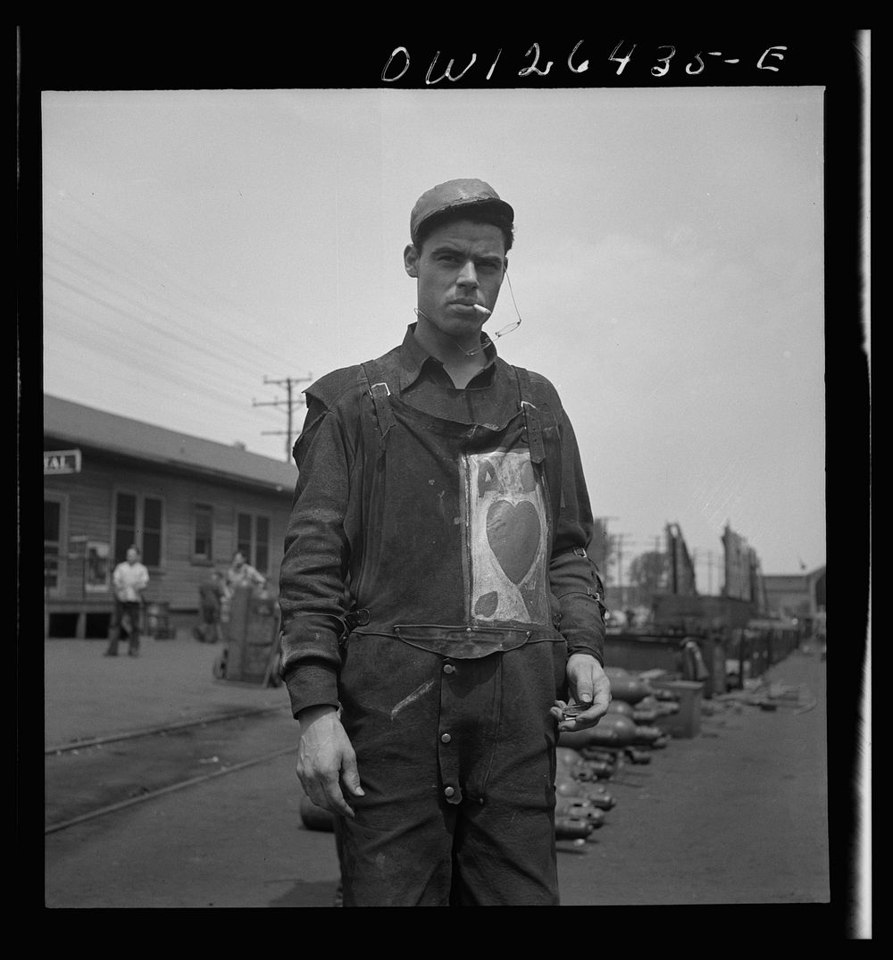 Bethlehem-Fairfield shipyards, Baltimore, Maryland. Worker with a personal monogram on his overalls. Sourced from the…