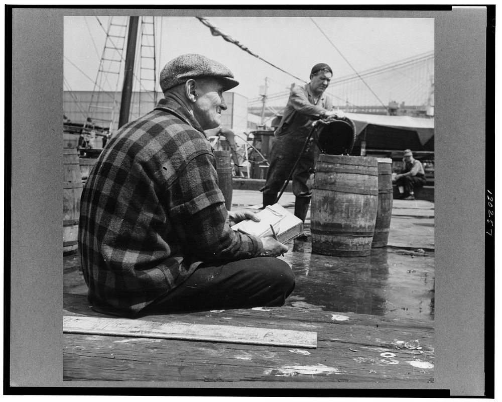 New York, New York. New England fisherman checking baskets of fish as they are lifted from his ship. Sourced from the…