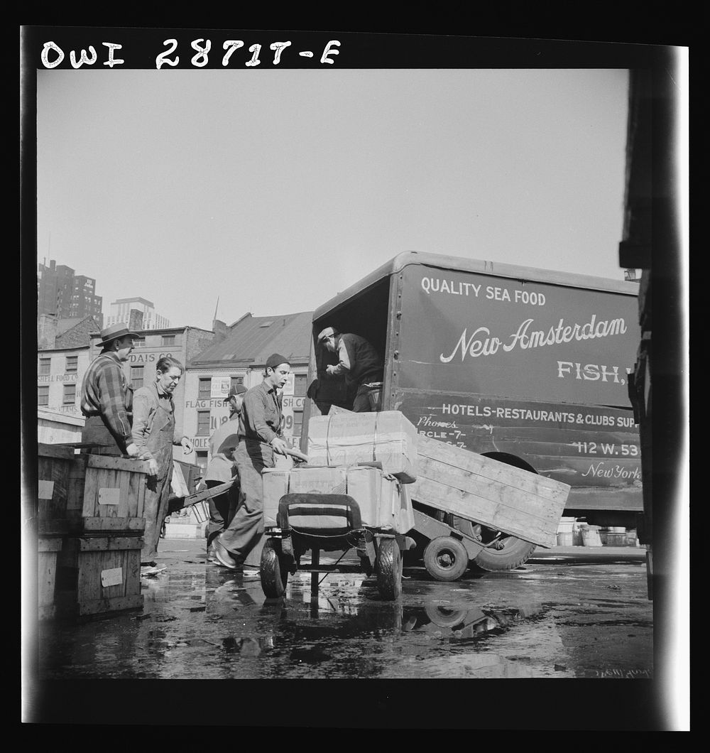 New York, New York. Loading boxes of fish to be shipped to hotels and restaurants at the Fulton fish market. Sourced from…