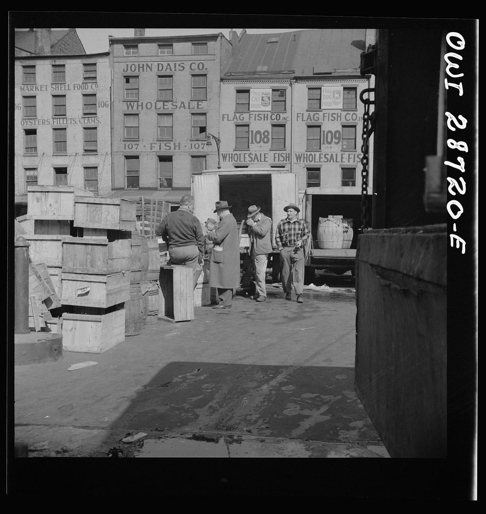 New York, New York. A buyer visits the wholesale district to purchase fish for his store. Sourced from the Library of…