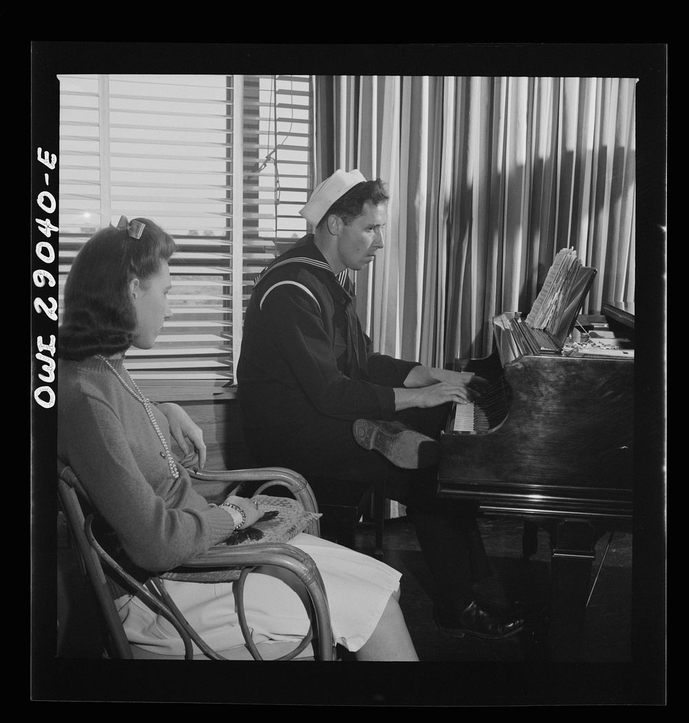 [Untitled photo, possibly related to: Arlington, Virginia. A group around a piano in the lounge of Idaho Hall, Arlington…