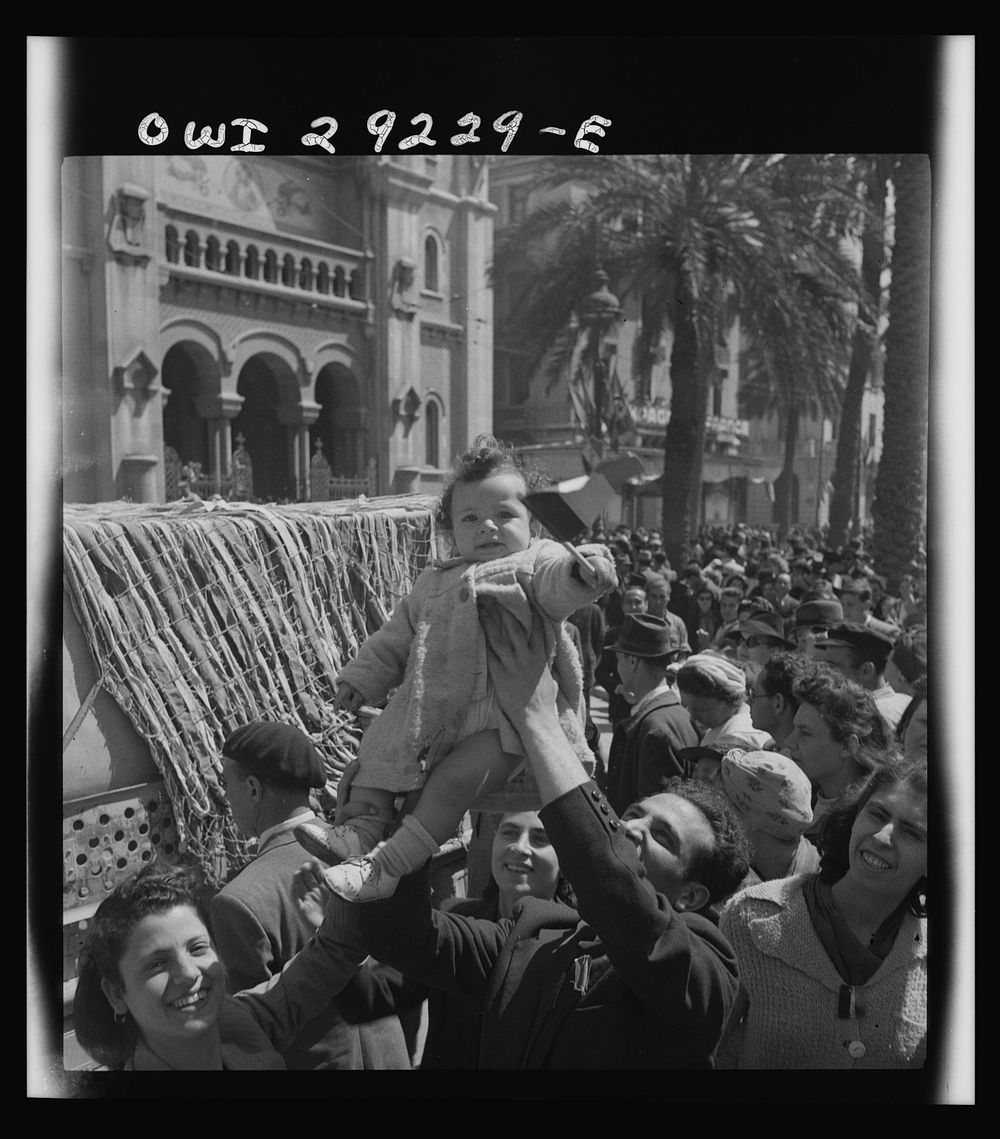 French citizens, in a frenzy of excitement, wave tricolors as Allied armies march into Tunis. Sourced from the Library of…