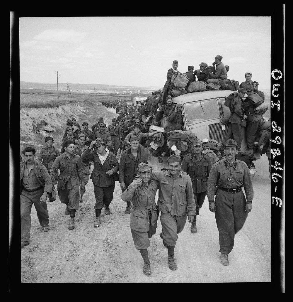 Axis prisoners of war are herded out of the city as Allied armies enter Tunis. Sourced from the Library of Congress.