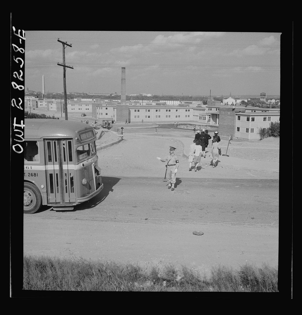 Arlington Farms, war duration residence halls. Crossing road in the front of Arlington Farms. A military police man acts as…