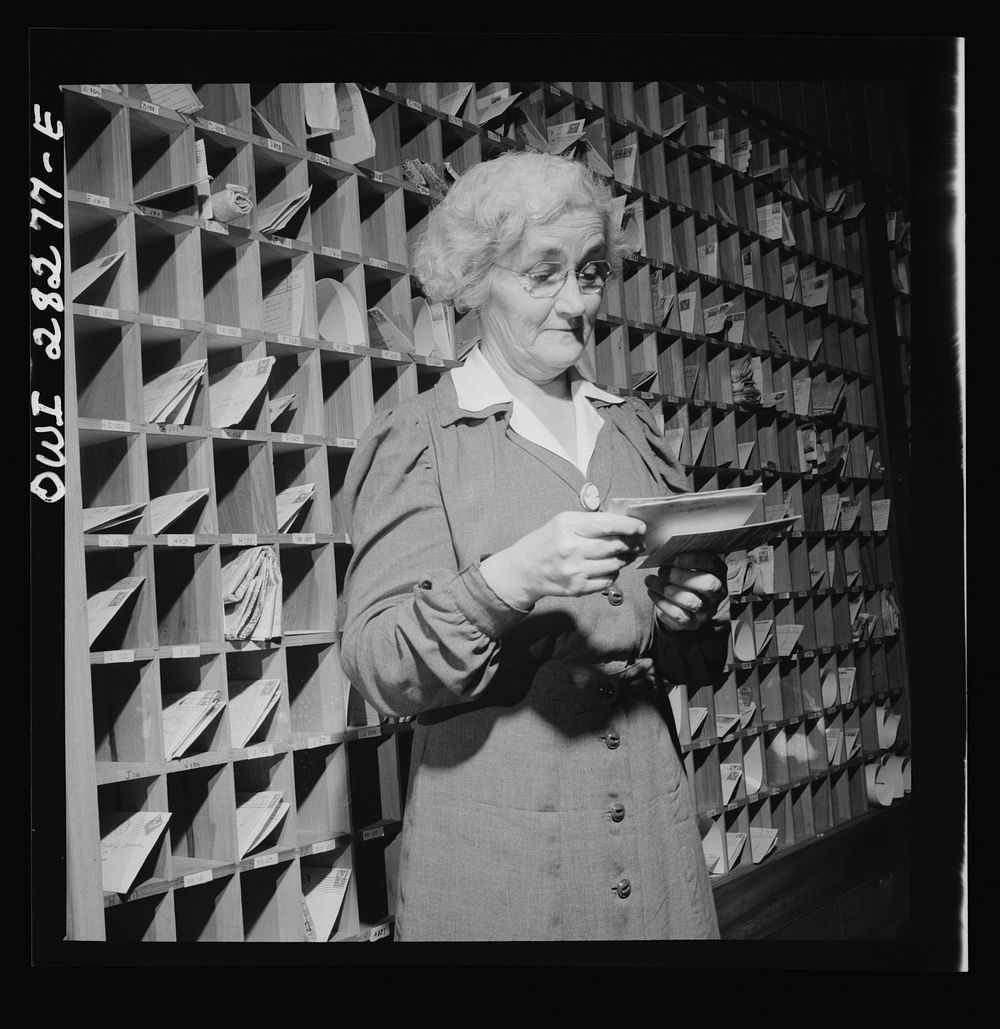 Arlington Farms, war duration residence halls. Desk clerk sorting the mail at Idaho Hall, Arlington Farms. Sourced from the…