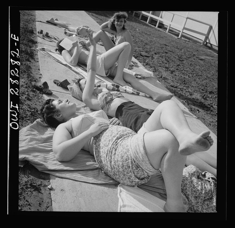 Arlington Farms, war duration residence halls. Sunbathers on the sidewalk in the back of Idaho Hall at Arlington Farms.…