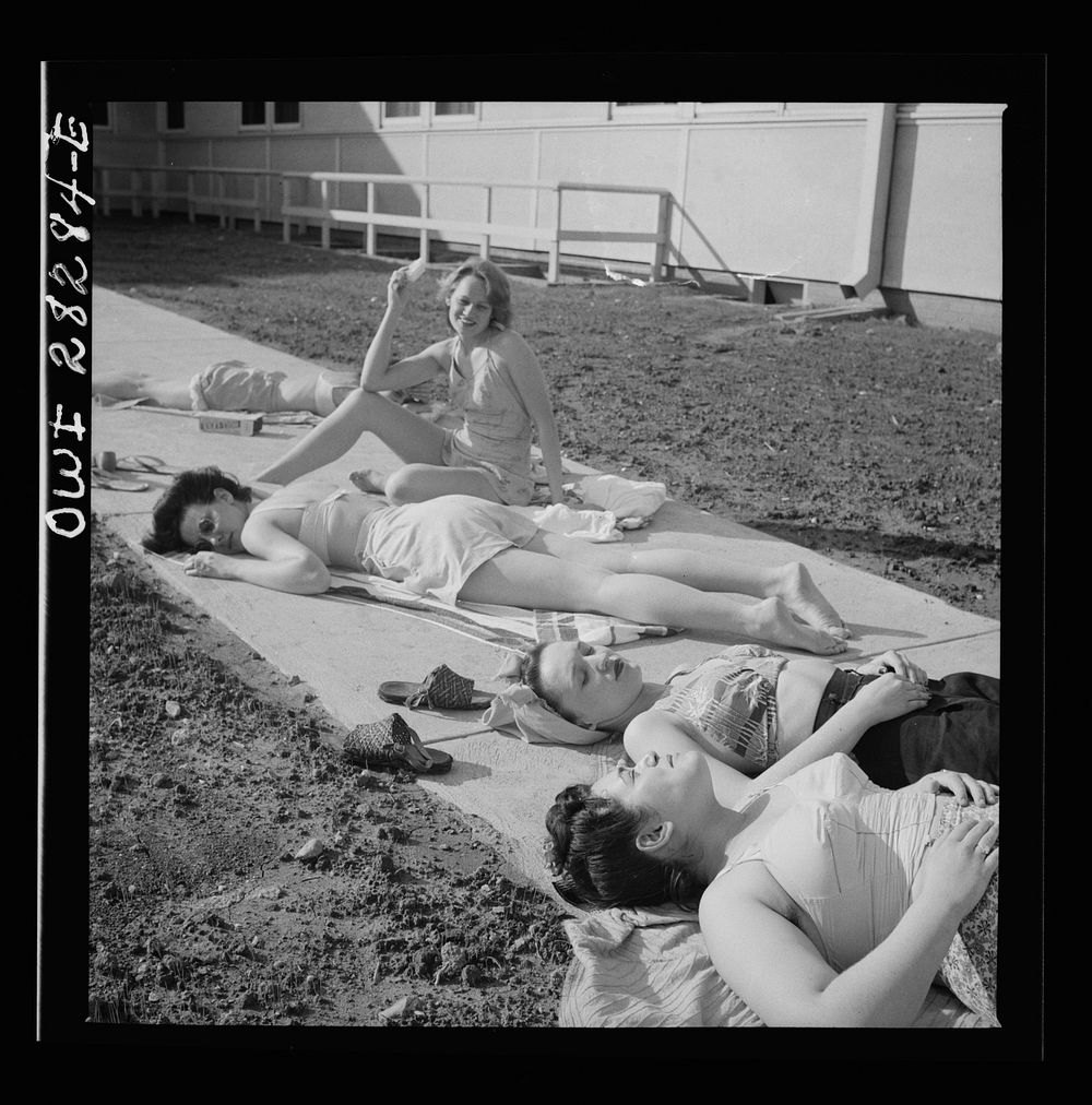 Arlington Farms, war duration residence halls. Sunbathers on the sidewalk in the back of Idaho Hall at Arlington Farms.…