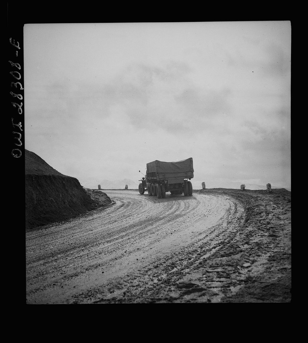 Somewhere in the Persian corridor. A United States Army truck convoy carrying supplies for the aid of Russia. Truck is shown…