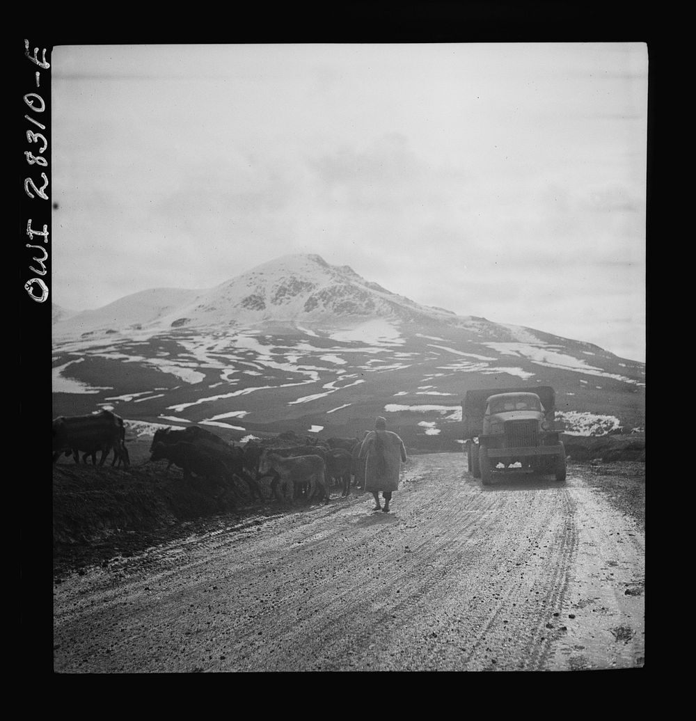 Somewhere in the Persian corridor. A United States Army truck convoy carrying supplies for the aid of Russia. An Iranian…