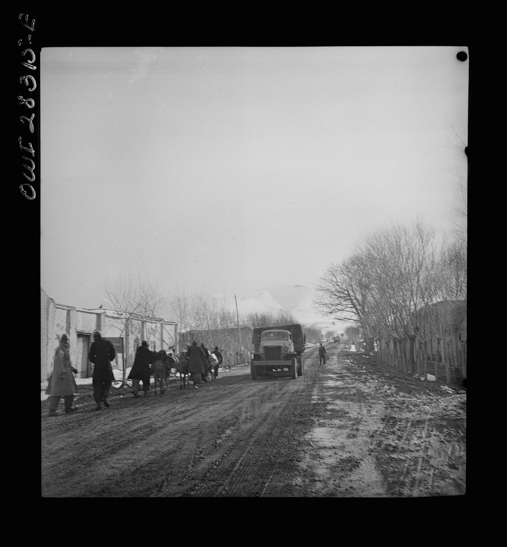 Somewhere in the Persian corridor. A United States Army truck convoy carrying supplies for the aid of Russia. The convoy…