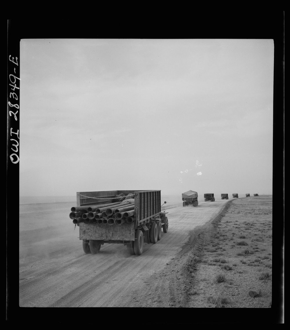 Somewhere in the Persian corridor. A United States Army truck convoy carrying supplies for Russia moving on a desert road.…